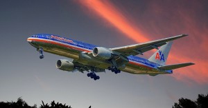 A commercial airplane flying at sunset with vibrant sky colors.