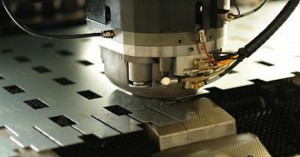 Close-up of a laser cutting machine engraving metal sheets.