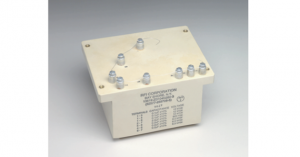 A beige electrical component with multiple terminals and printed specifications.