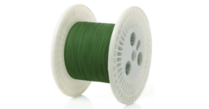 Spool of green filament wire for 3D printing or crafting.