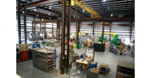 Inside a spacious industrial workshop with machinery and workstations.