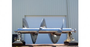 Close-up of a large metallic industrial screw conveyor.